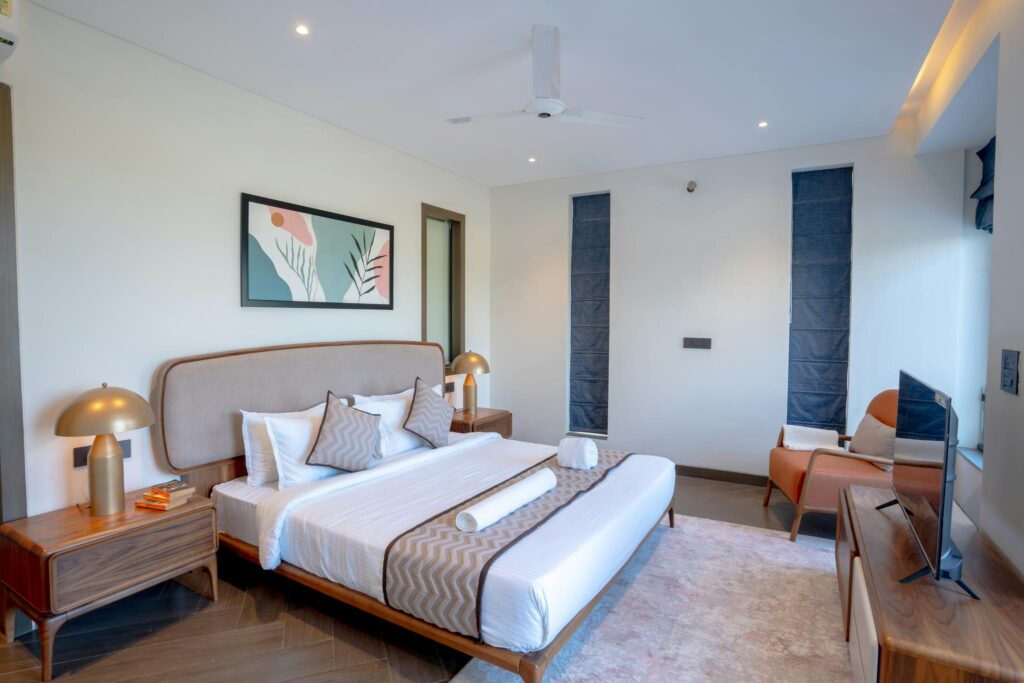 Elegant interior design of a luxury villa bedroom in Saligao, Goa, showcasing modern aesthetics.