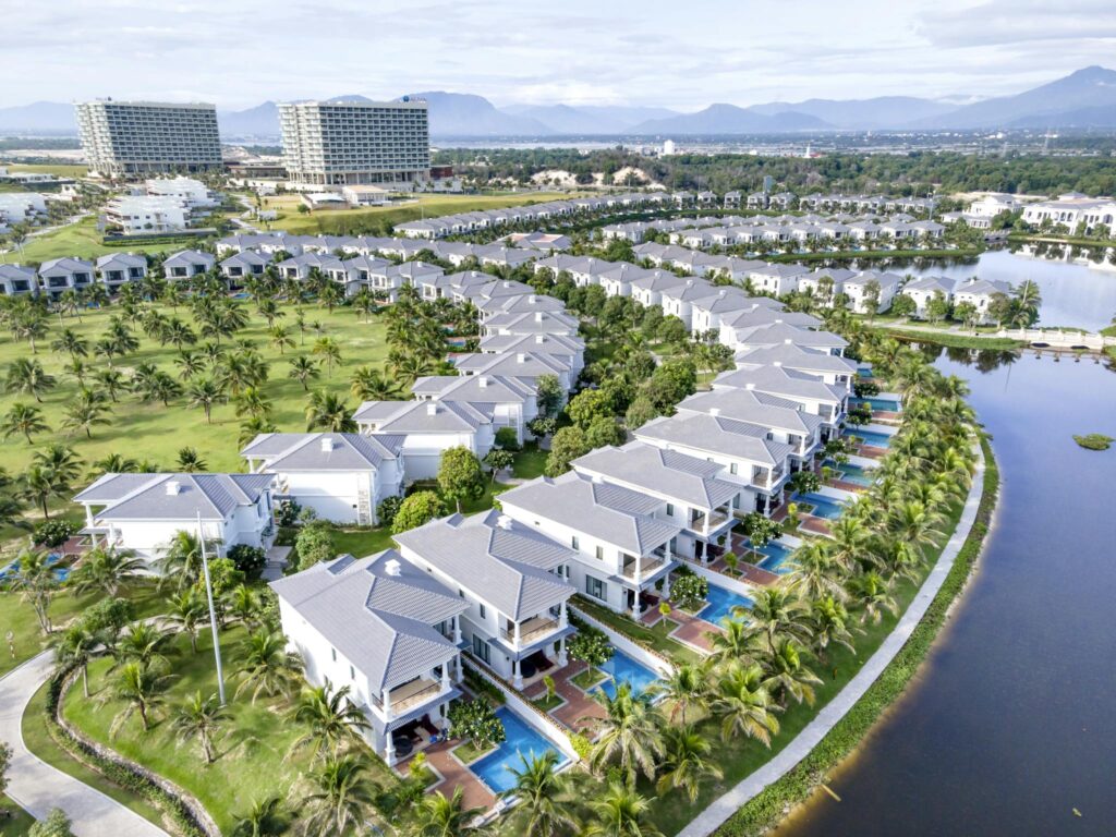 Stunning aerial image showcasing luxury villas with private pools at a resort in Vietnam.